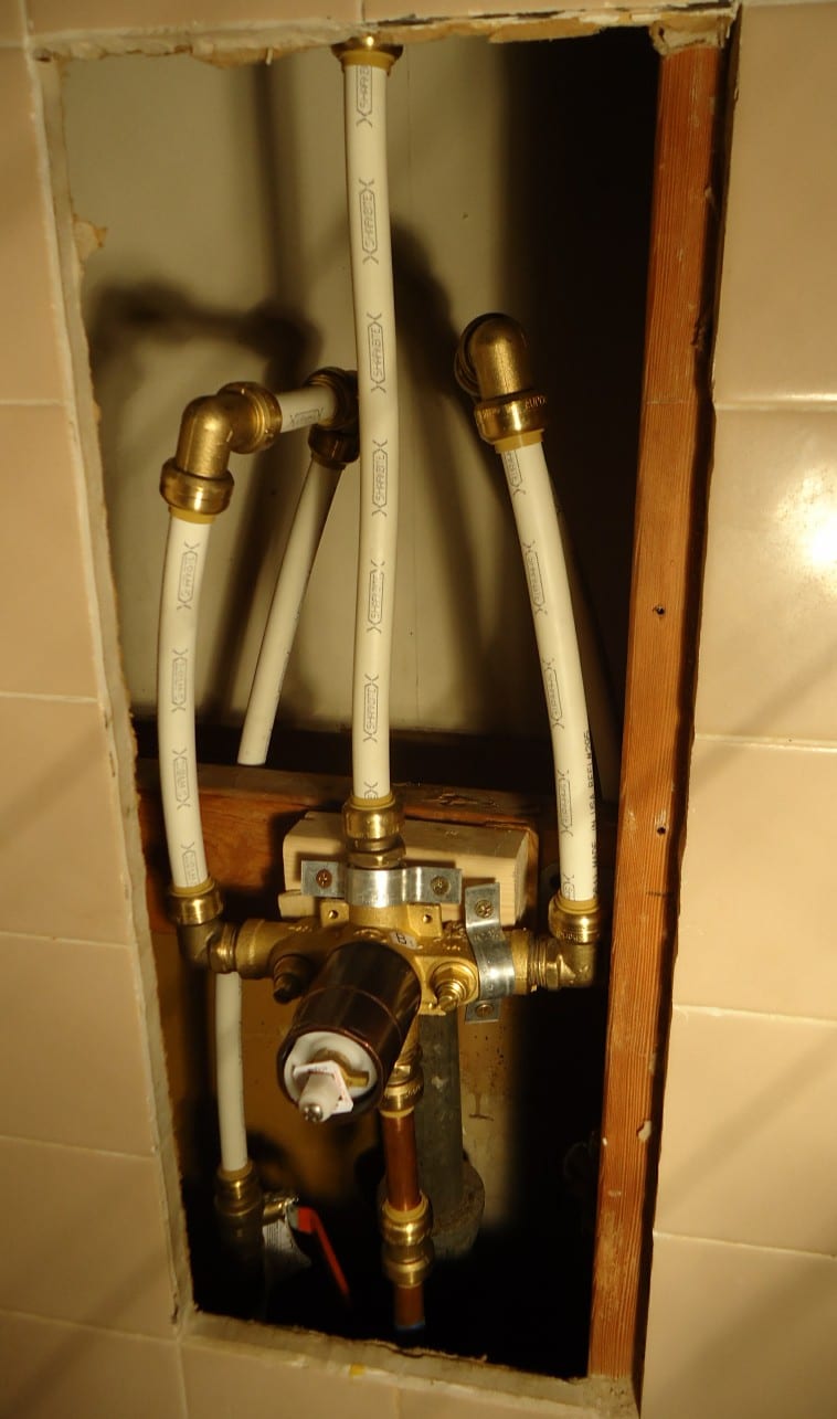 Shower diverter valve and connected PEX pipework in an open wall